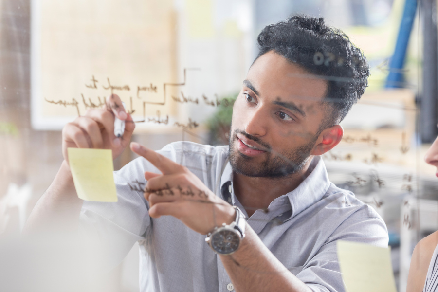 Man writing on post-it notes in planning exercise