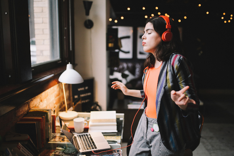 Woman in headphones dancing to music